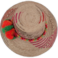 Boho Wayuu hat Florence featuring pink palm fiber design and bold green-orange pompoms

