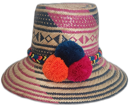 Handmade Wayuu straw hat with navy and fuchsia weave and pompoms in navy, orange, and fuchsia.

