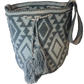 Gray and cream boho chick crochet bag with tribal Wayuu pattern and tassel drawstring, ideal as a shoulder or crossbody accessory.