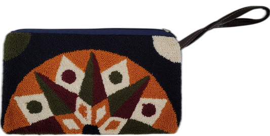 Bohemian punch-needle clutch with handcrafted Wayuu design in black, orange, and cream tones. A perfect colorful and artistic accessory for boho style.