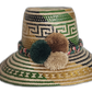Handmade Wayuu straw hat with green, brown, and cream pompoms