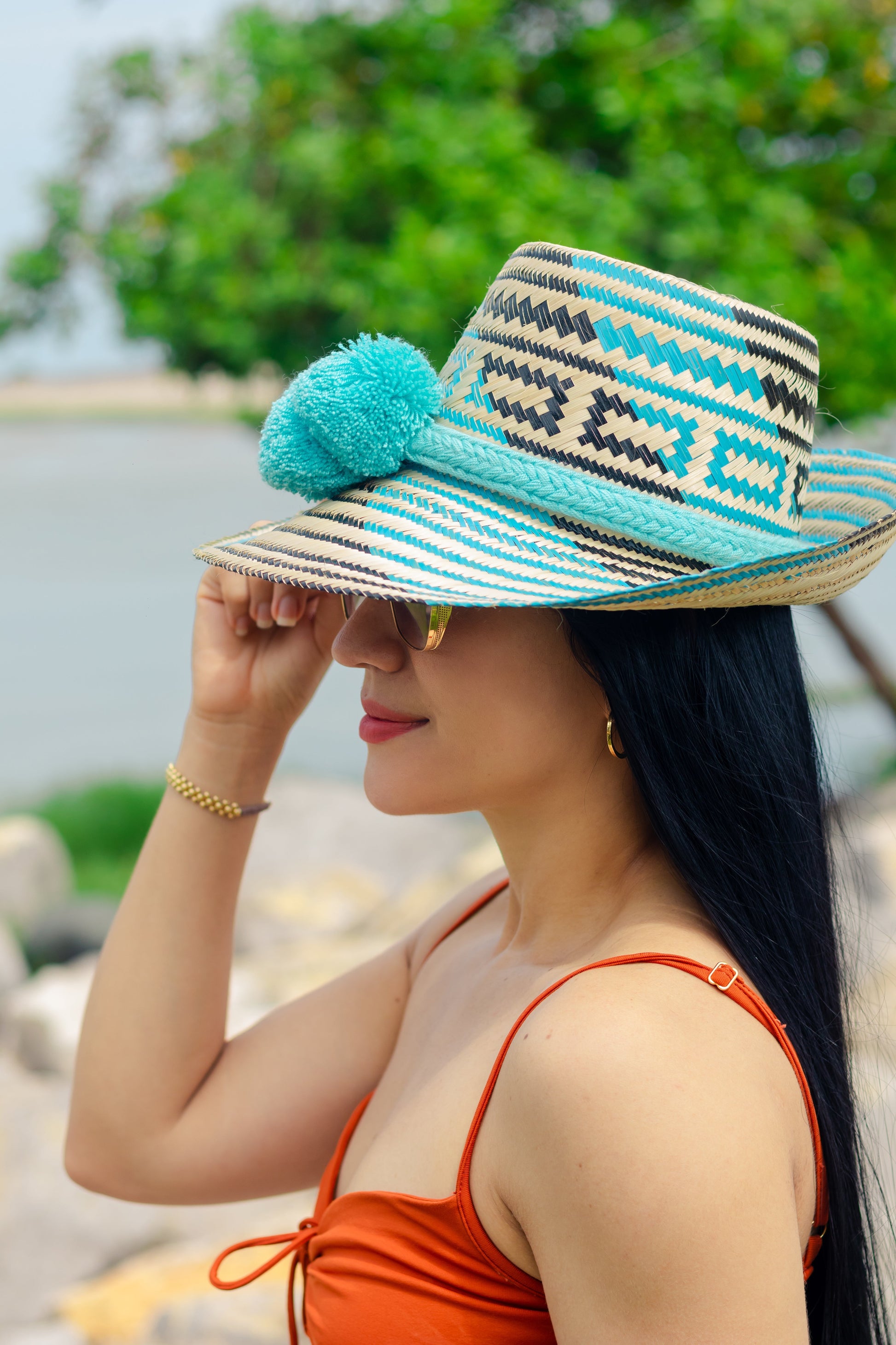 Bottom view "Handcrafted colorful straw hat by Wayuu artisans using Iraca palm fibers, with adjustable weave and cultural pompoms."