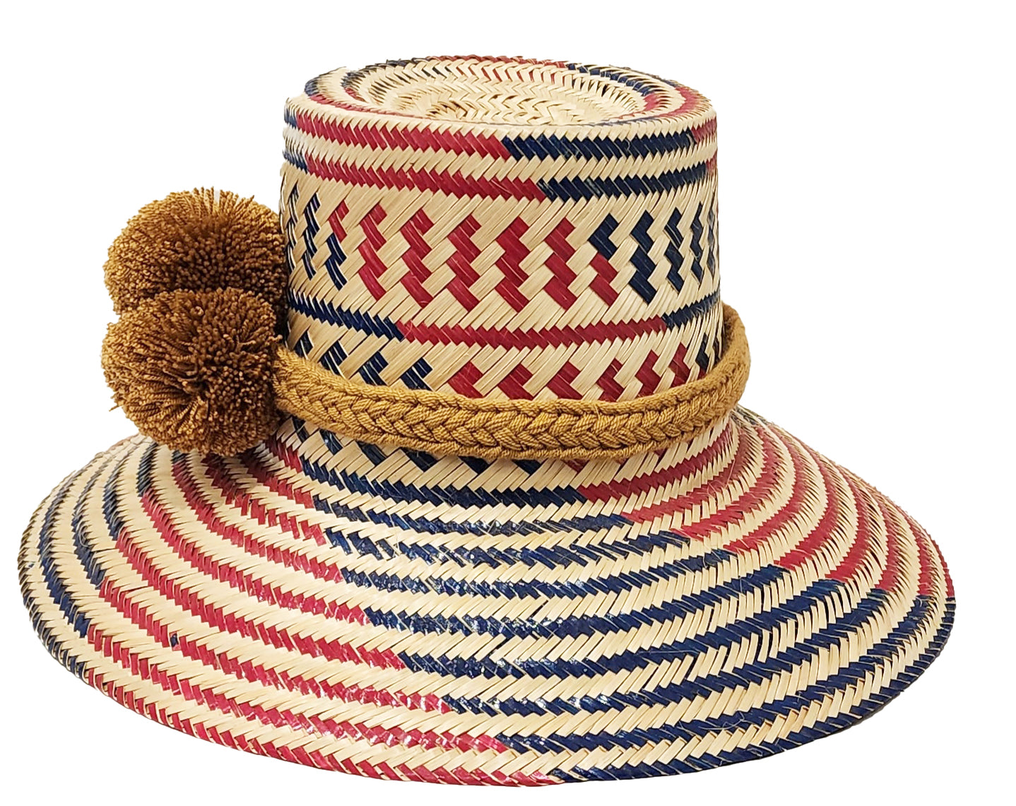 "Handcrafted colorful straw hat by Wayuu artisans using Iraca palm fibers, with adjustable weave and cultural pompoms."