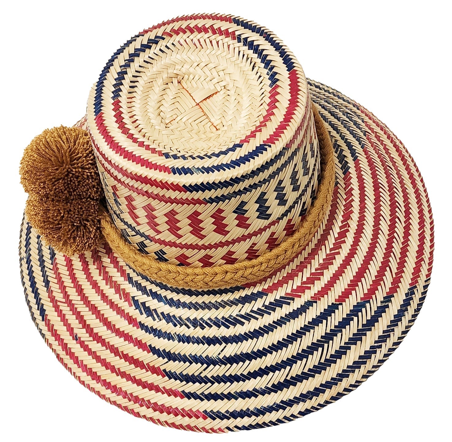 "Handcrafted colorful straw hat by Wayuu artisans using Iraca palm fibers, with adjustable weave and cultural pompoms."