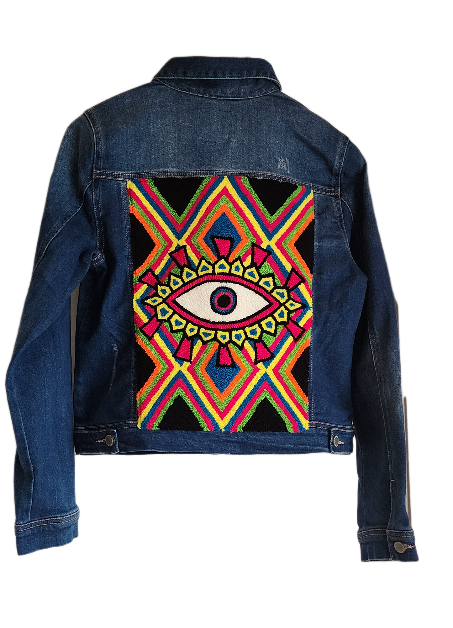 "Handcrafted denim jacket with colorful punch needle embroidery on the back, showcasing unique Wayuu-inspired patterns and fa