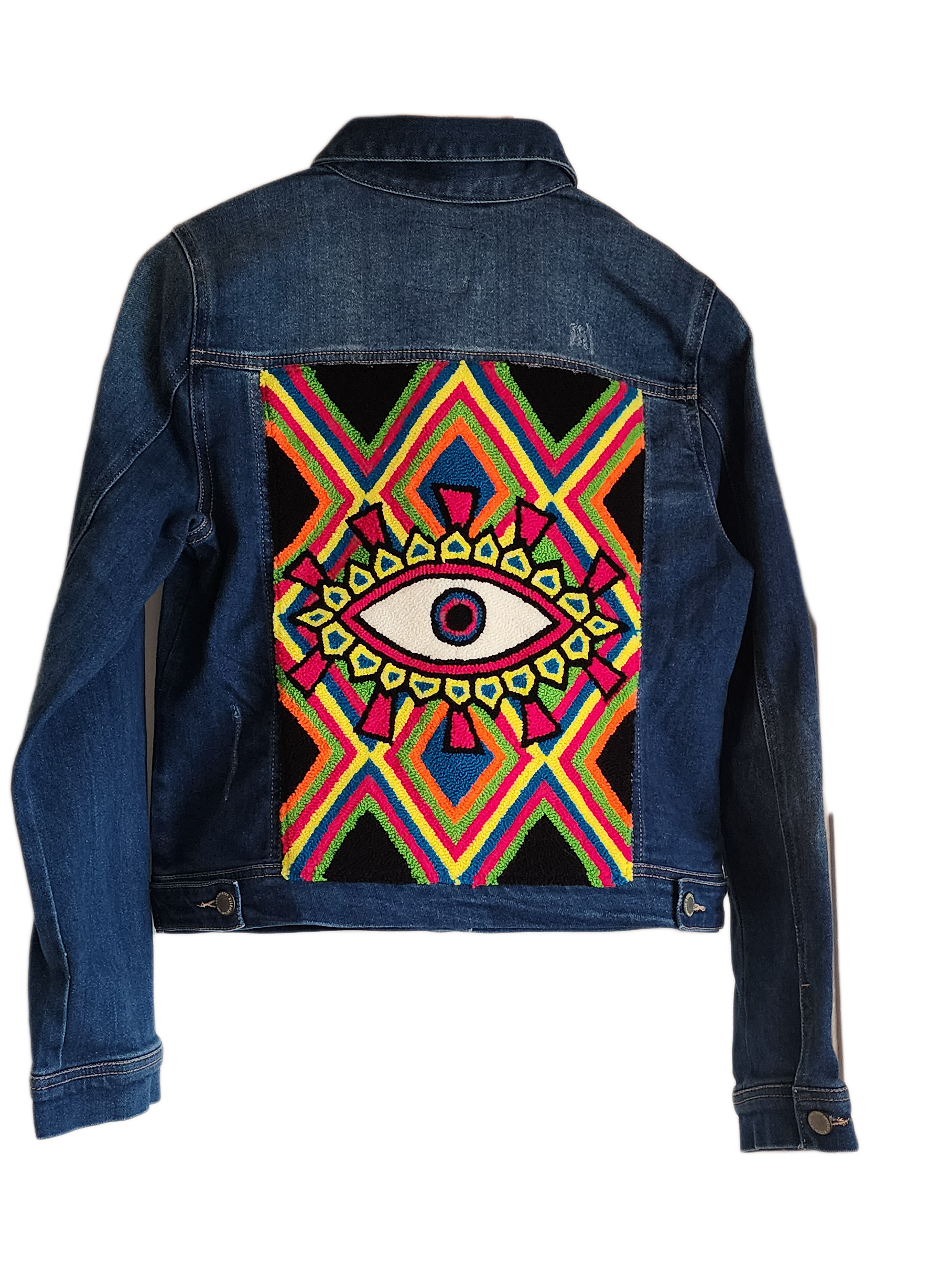 "Handcrafted denim jacket with colorful punch needle embroidery on the back, showcasing unique Wayuu-inspired patterns and fa