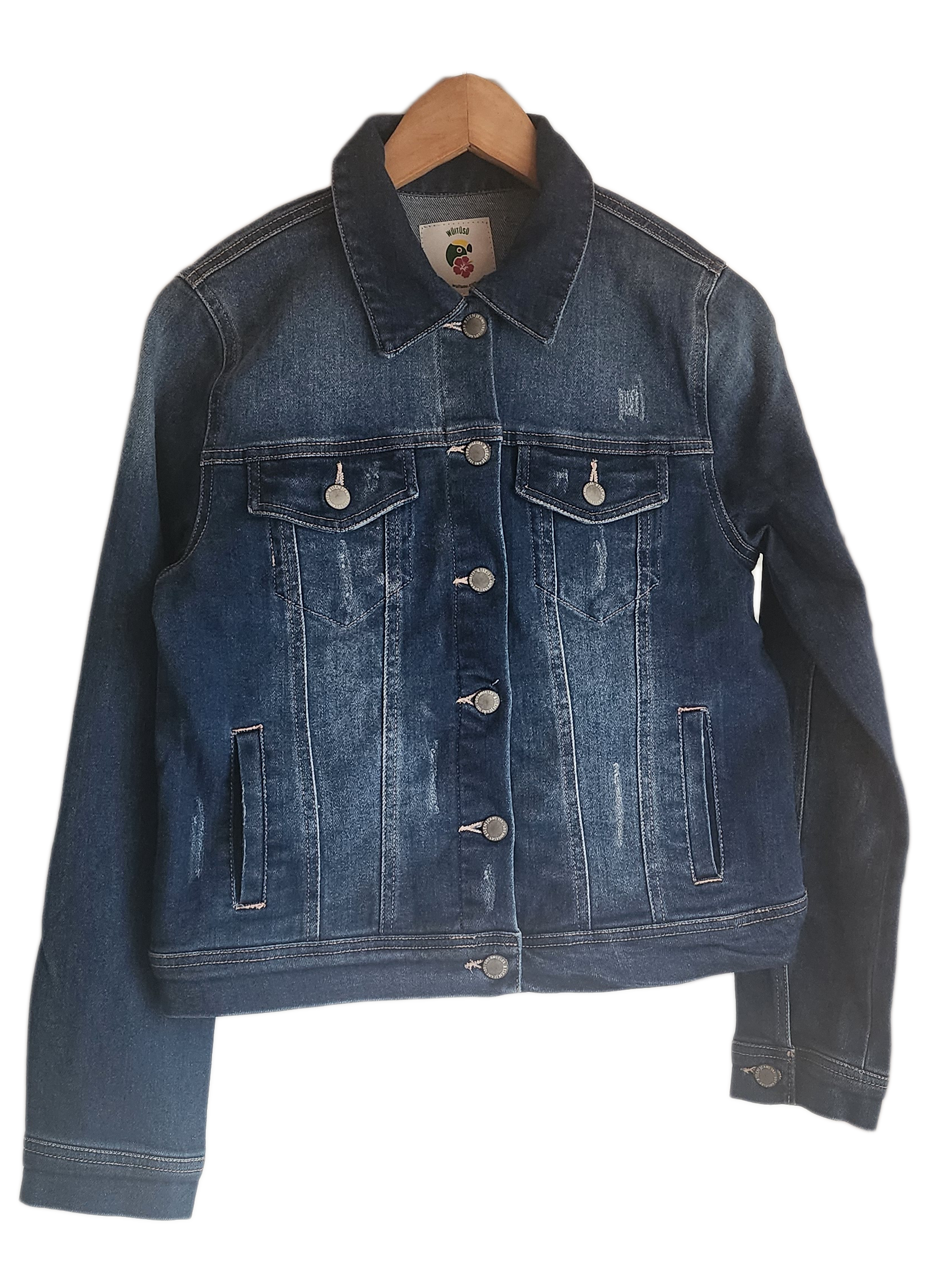 "Handcrafted denim jacket with vibrant, Wayuu-inspired punch needle embroidery on the back, showcasing artisanal craftsmanshi