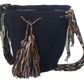Bohemian black Wayuu bag featuring intricate colorful tassels and traditional artisan craftsmanship.