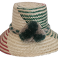 Wayuu handmade straw hat with green and red weave, neutral braided band, and soft pom-poms — artisan-crafted.
