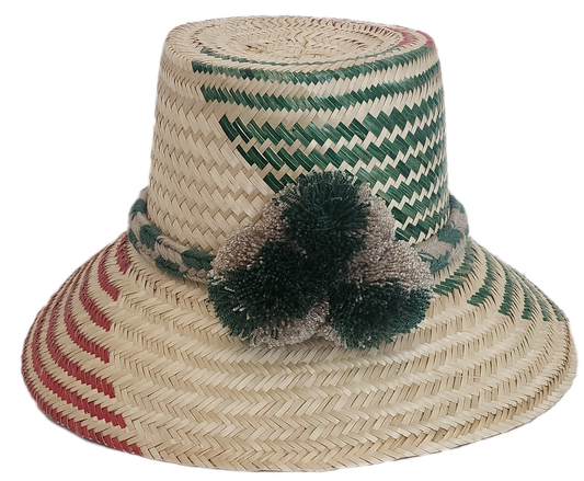 Wayuu handmade straw hat with green and red weave, neutral braided band, and soft pom-poms — artisan-crafted.