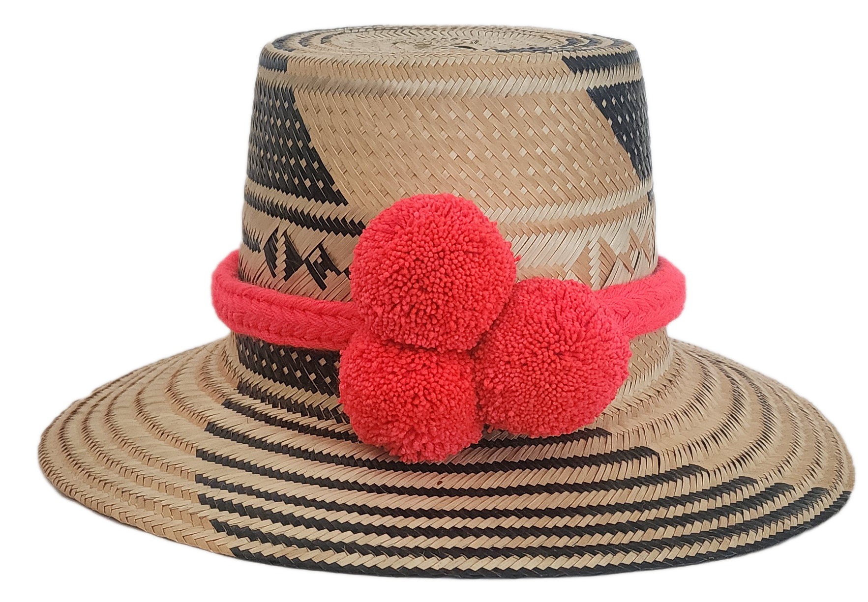 Wayuu straw hat with black geometric weave and bright red pom-poms — handmade boho accessory.