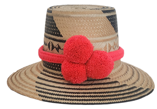 Wayuu straw hat with black geometric weave and bright red pom-poms — handmade boho accessory.