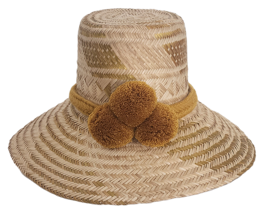 Handwoven Wayuu straw hat featuring a wide brim and mustard yellow pom-pom band. This bohemian, artisan-crafted hat blends traditional Wayuu design with a modern boho-chic style — perfect for sunny days, festivals, or beachwear.