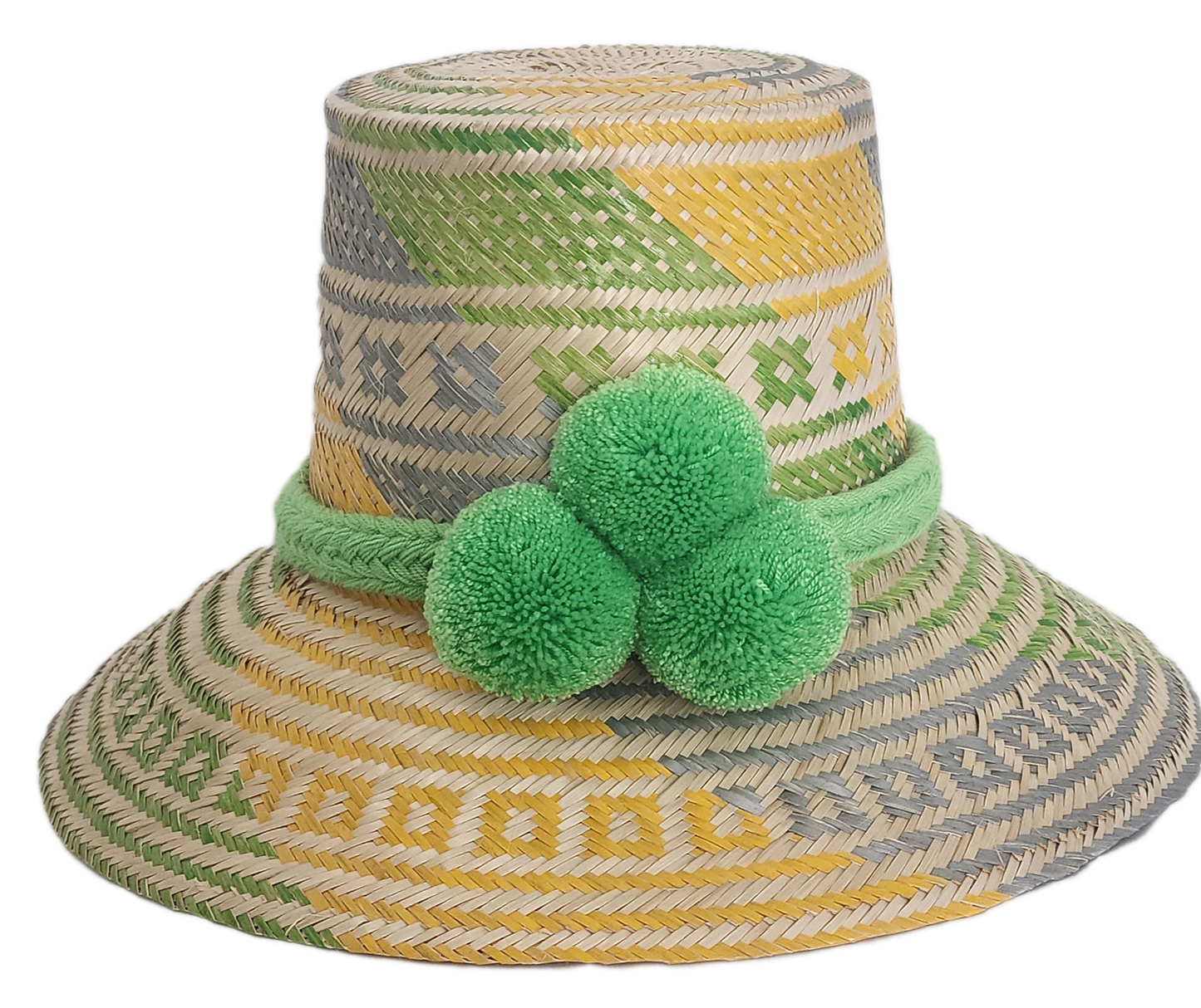 Handwoven Wayuu straw hat with green, yellow, and gray tribal patterns, wide brim, and bright green pom-pom band. A bold, bohemian summer accessory.