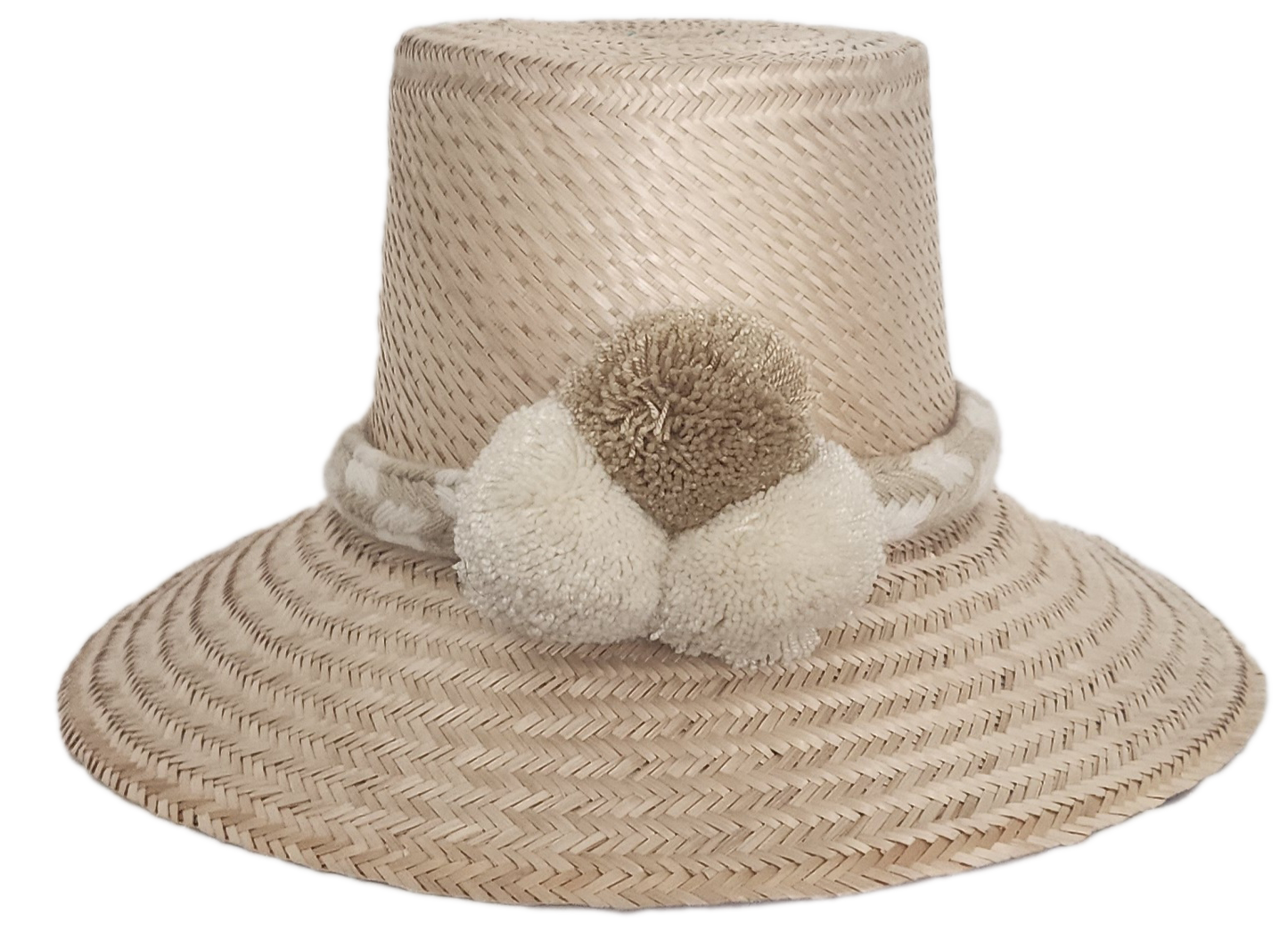 Handwoven Wayuu straw hat in soft beige tones, featuring a wide brim and braided band adorned with neutral cream and taupe pom-poms. Elegant boho style.