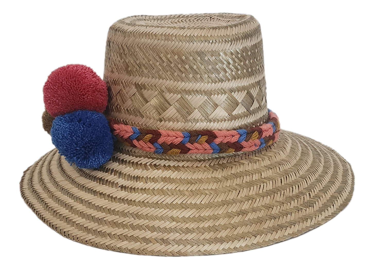 Boho-style handmade straw hat with vibrant pom-poms and woven band — crafted by Wayuu artisans for colorful summer fashion.