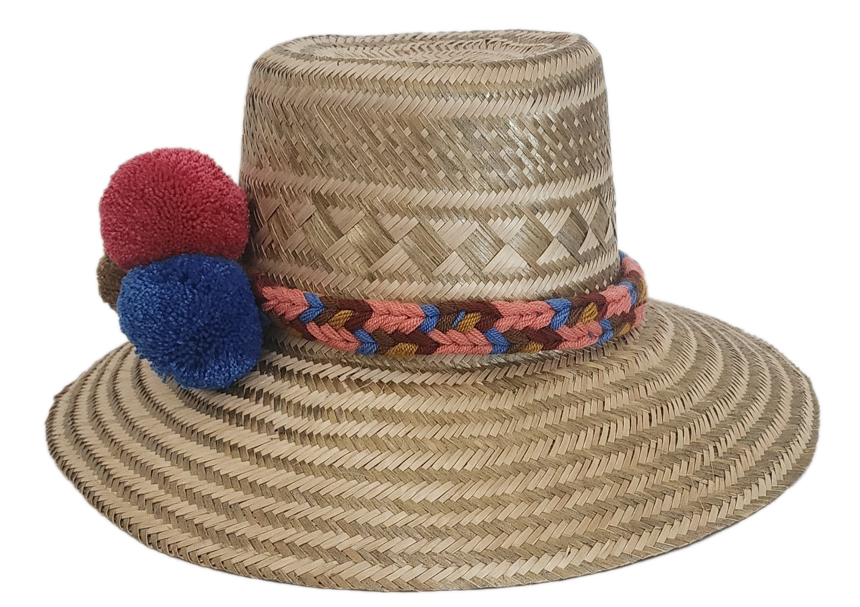 Boho-style handmade straw hat with vibrant pom-poms and woven band — crafted by Wayuu artisans for colorful summer fashion.