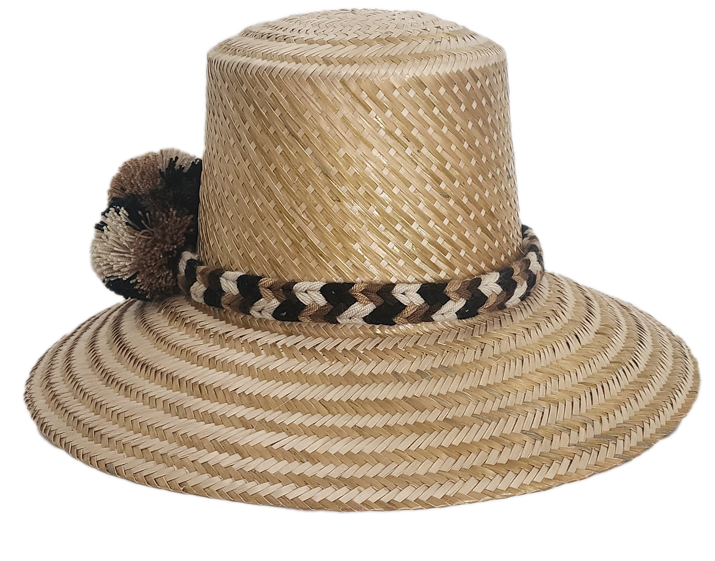 Handwoven Wayuu straw hat in a natural finish, featuring a braided band with earth-toned pom-poms in black, beige, and brown. A timeless boho accessory.