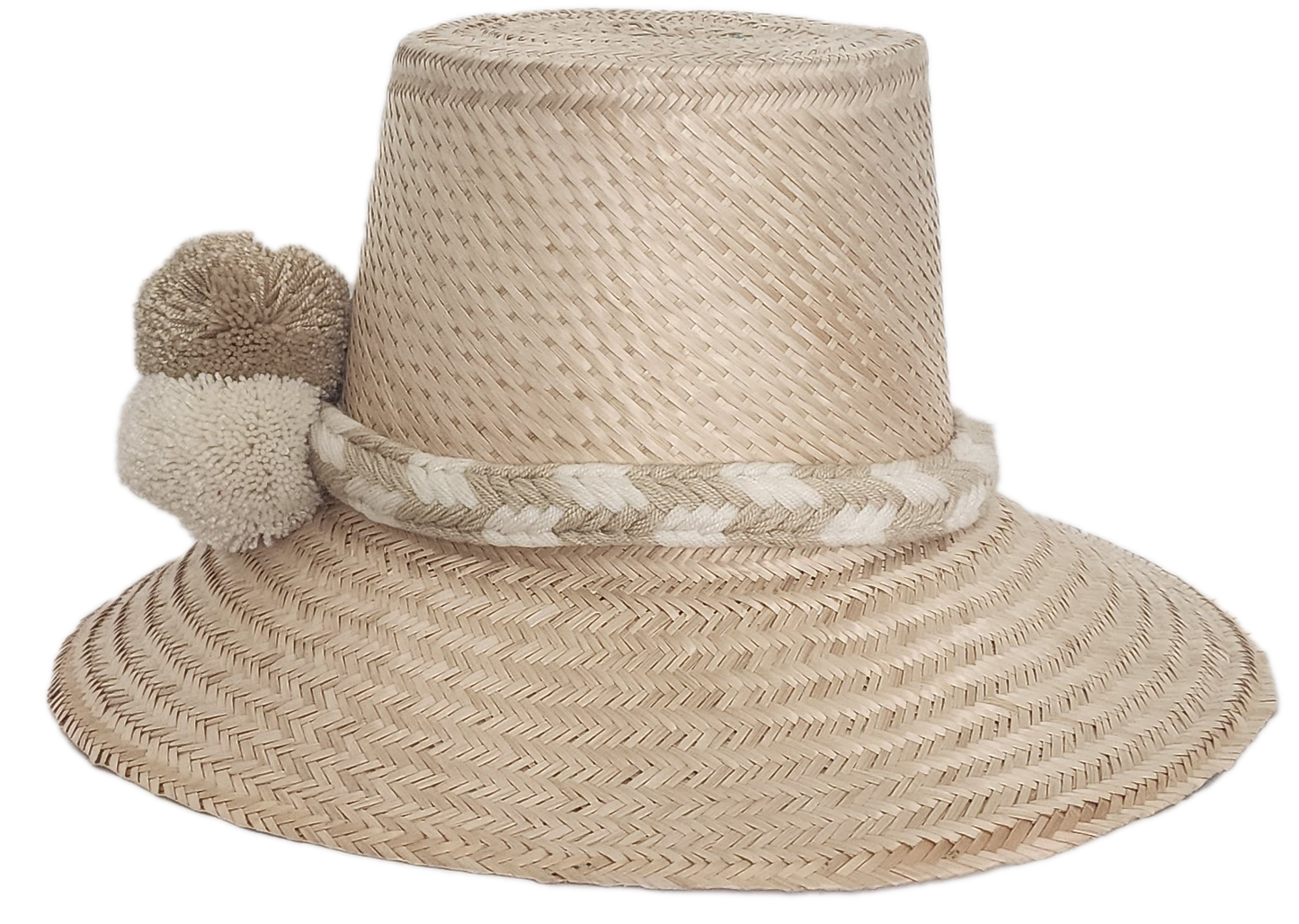 Handwoven Wayuu straw hat in soft beige tones, featuring a wide brim and braided band adorned with neutral cream and taupe pom-poms. Elegant boho style.