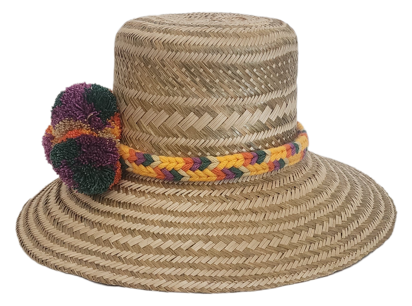 Bohemian Wayuu hat handmade with straw and adorned with colorful yarn pom-poms and a braided band.