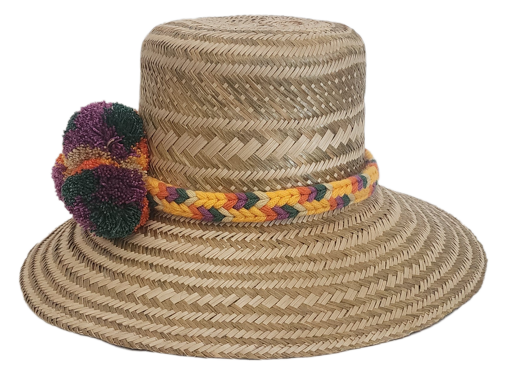 Bohemian Wayuu hat handmade with straw and adorned with colorful yarn pom-poms and a braided band.