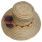 Eco-friendly Wayuu straw sun hat with colorful pom-poms and handwoven band — handmade and bohemian.
