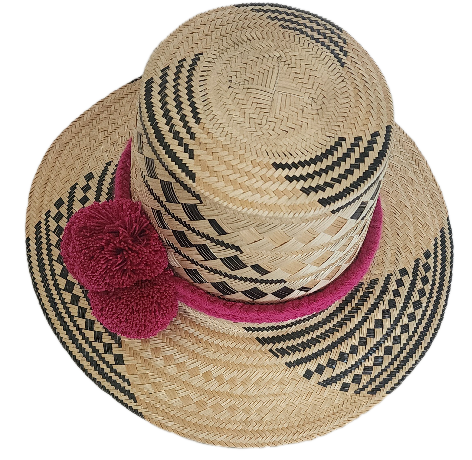 Traditional Wayuu straw hat with magenta details and bold black pattern — colorful and bohemian.