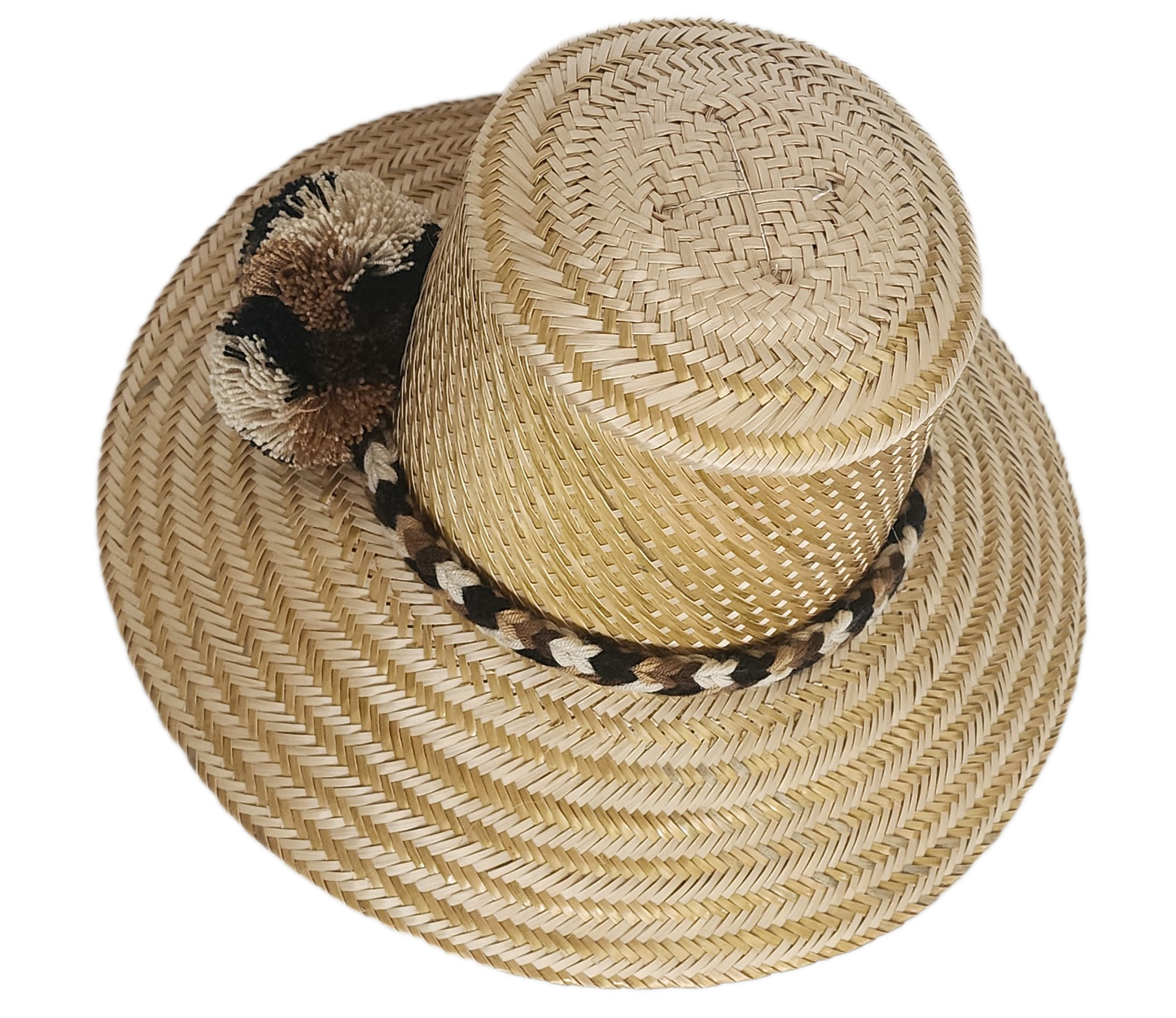 Handwoven Wayuu straw hat in a natural finish, featuring a braided band with earth-toned pom-poms in black, beige, and brown. A timeless boho accessory.