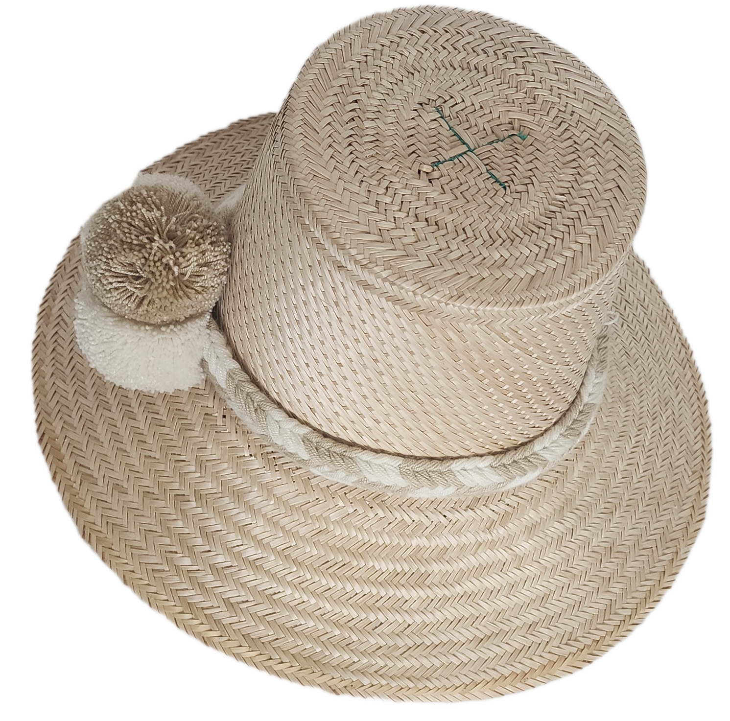 Handwoven Wayuu straw hat in soft beige tones, featuring a wide brim and braided band adorned with neutral cream and taupe pom-poms. Elegant boho style.