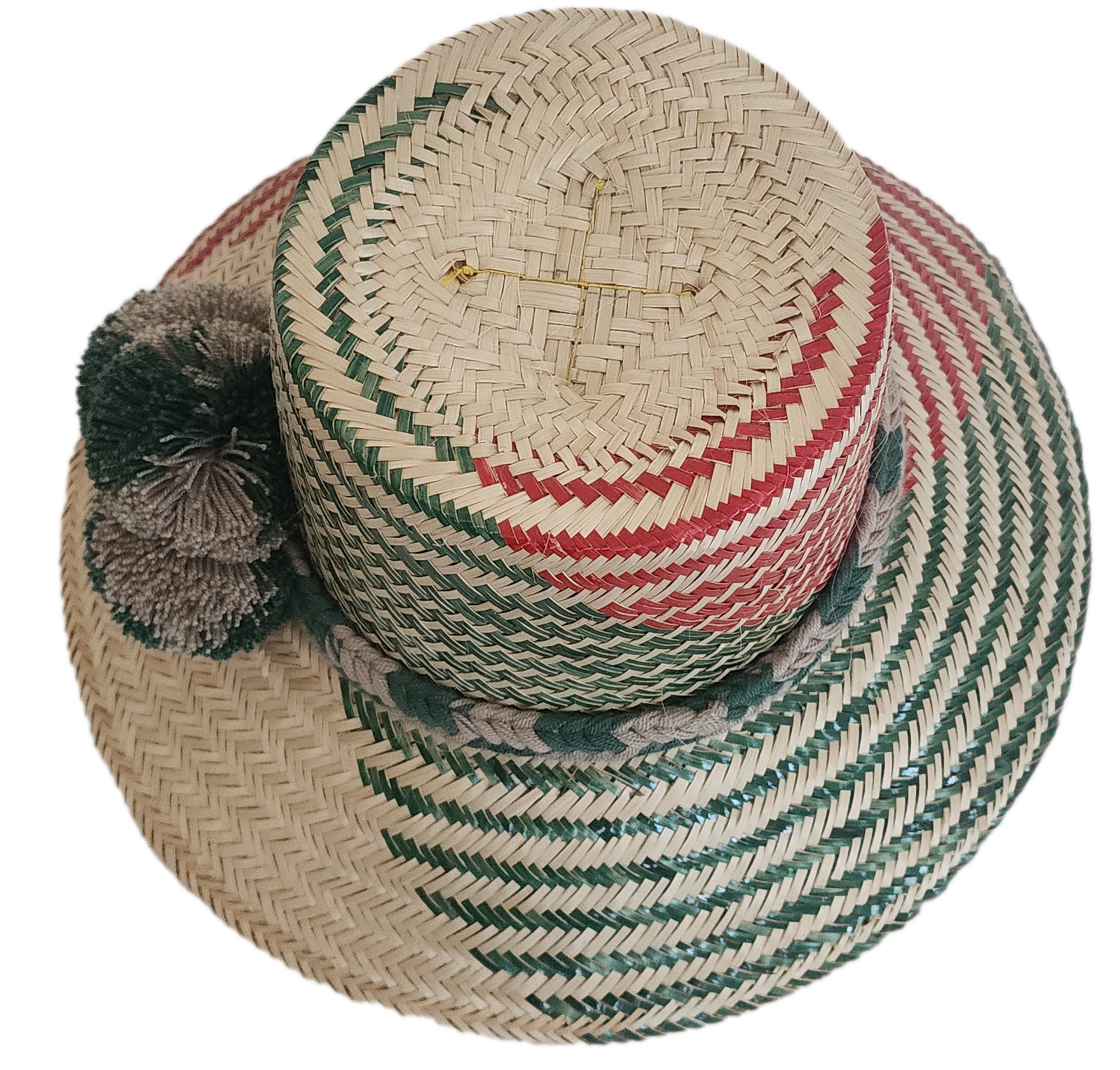 Handcrafted Wayuu straw hat with natural green-red chevron weave and neutral-toned pom-poms.