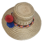 Artisan-crafted Wayuu straw hat with colorful handwoven band and decorative pom-poms — bohemian and eco-friendly.
