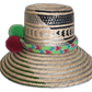 Bohemian straw hat crafted with Iraca palm, featuring colorful band and pompoms