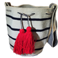 Nautical-inspired boho chick bag featuring bold red tassels and stripes.