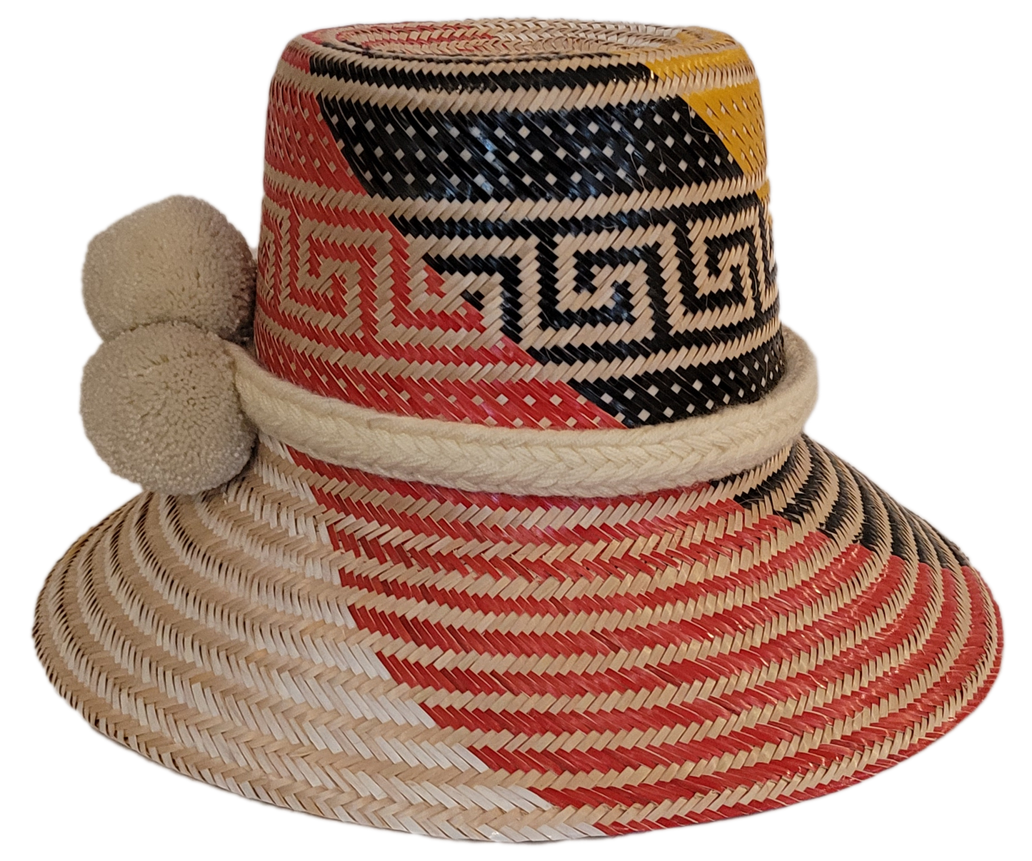 Boho Chick straw hat featuring vibrant red, yellow, and white pattern with soft white pompoms.