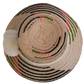 Unique handmade straw hat from Wayuu artisans, featuring bold black patterns and white pom accent.