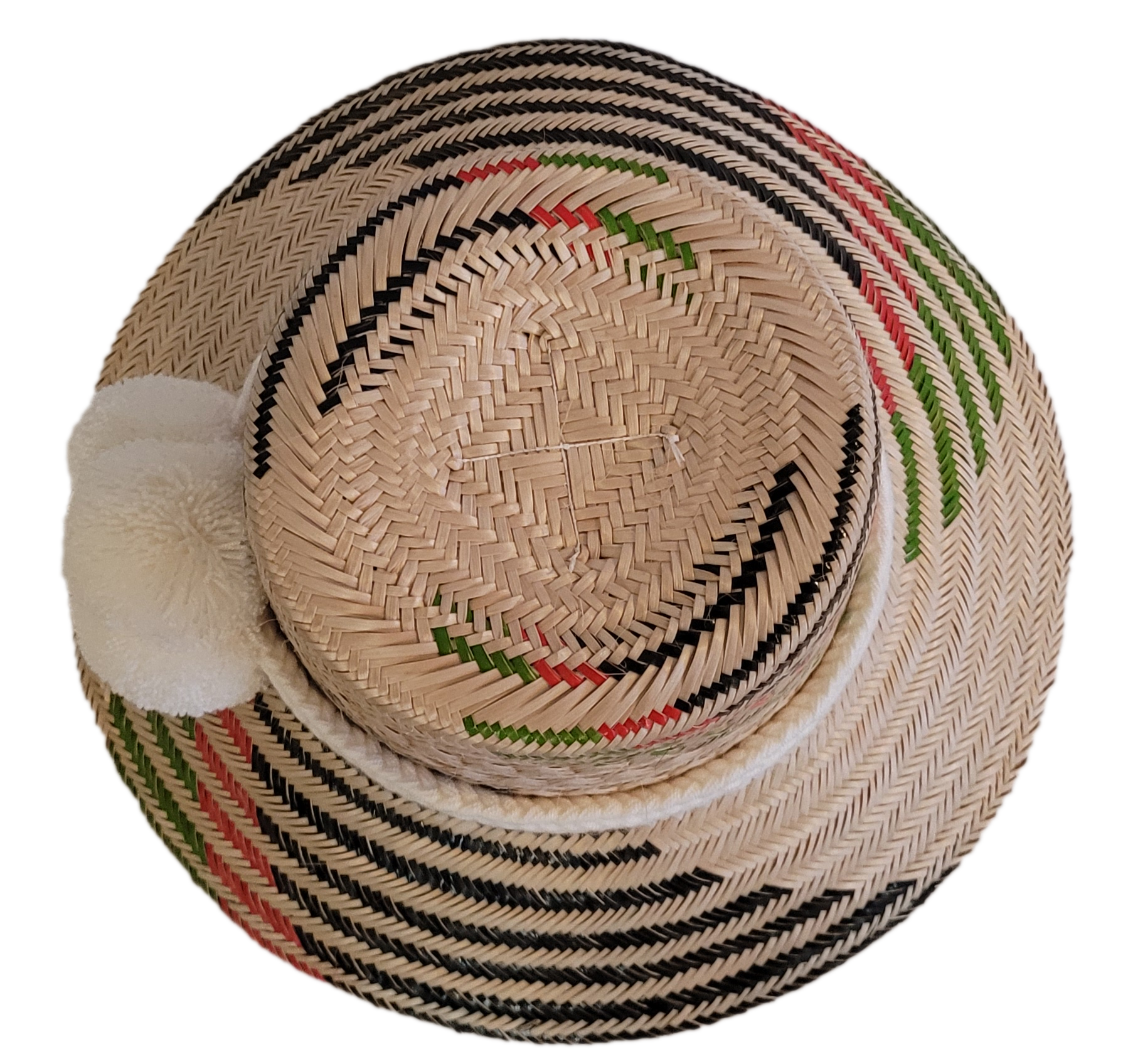 Unique handmade straw hat from Wayuu artisans, featuring bold black patterns and white pom accent.