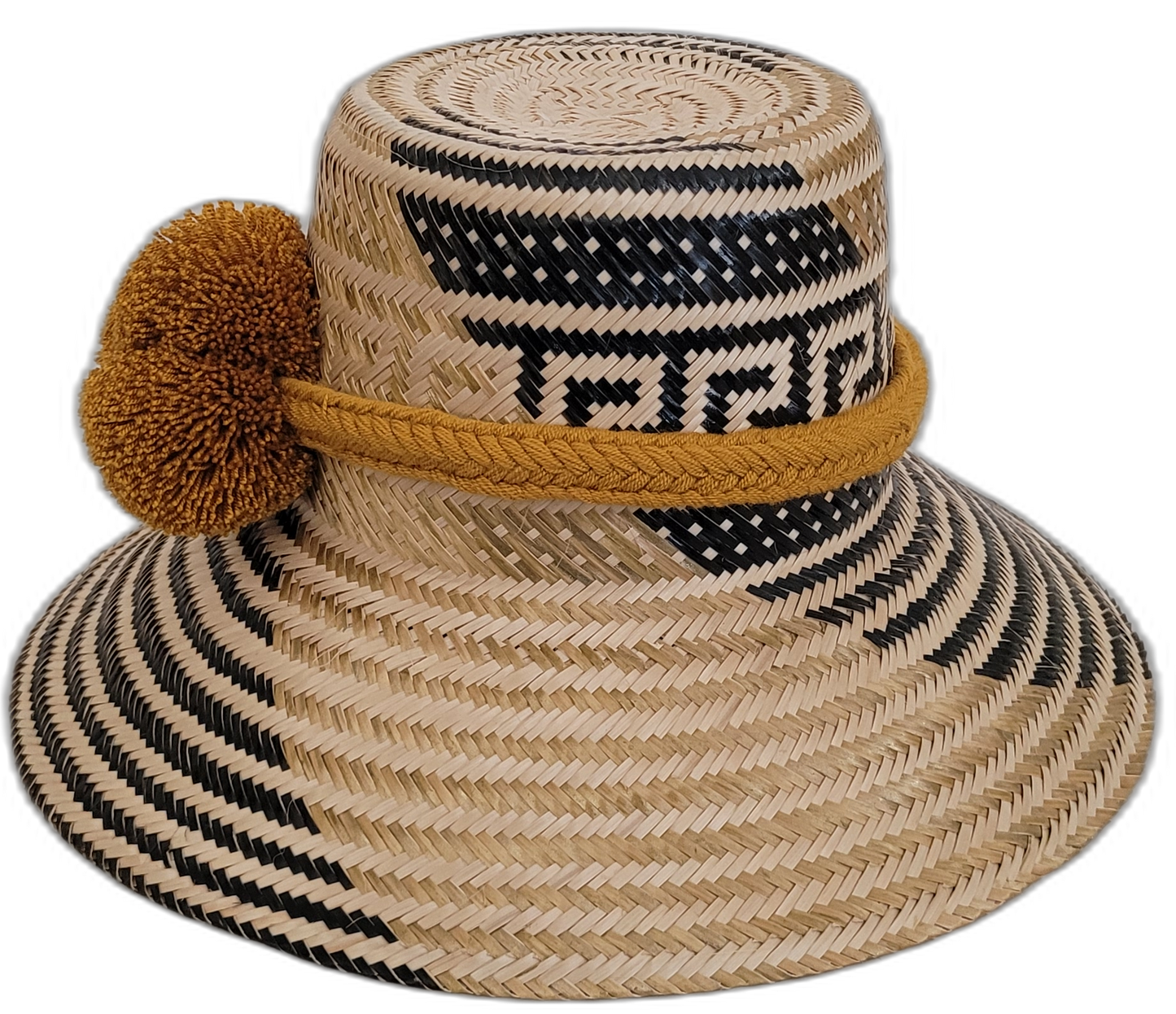 Unique Wayuu artisan straw hat, featuring bold black weave and golden mustard pompom accents.

