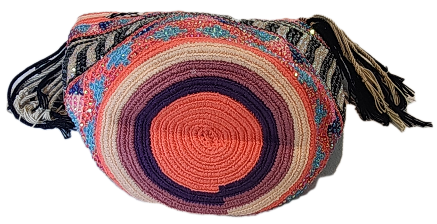 "Handmade colorful Wayuu crochet bag with intricate patterns and adjustable straps, showcasing sustainable and ethical fashio