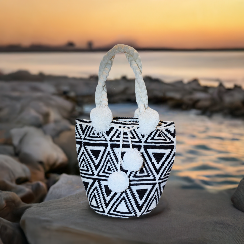 "Handmade colorful Wayuu crochet bag with vibrant patterns and short handle, embodying Wayuu culture and artisan craftsmanshi