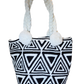 "Handmade colorful Wayuu crochet bag with vibrant patterns and short handle, embodying Wayuu culture and artisan craftsmanshi