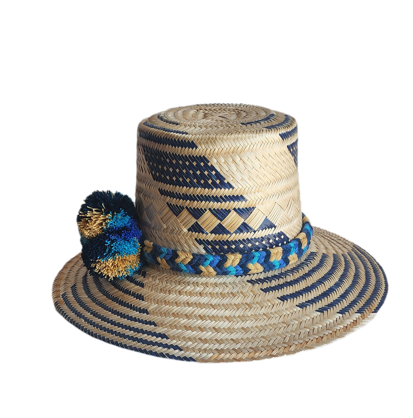 "Handmade, colorful Wayuu hat crafted from Iraca palm, adorned with meaningful pompoms, demonstrating artisan craftsmanship."