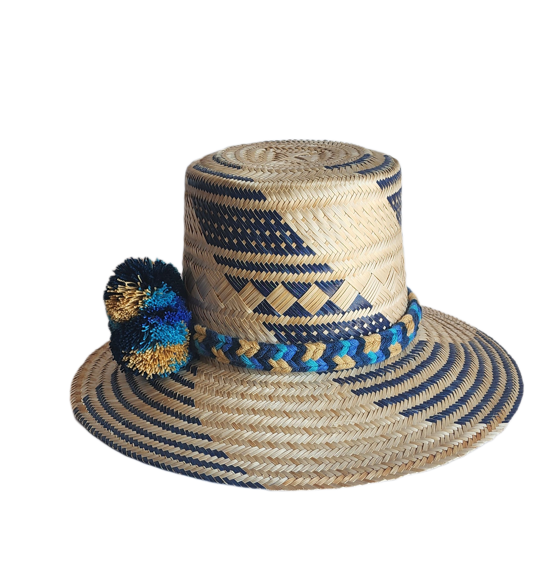"Handmade, colorful Wayuu hat crafted from Iraca palm, adorned with meaningful pompoms, demonstrating artisan craftsmanship."