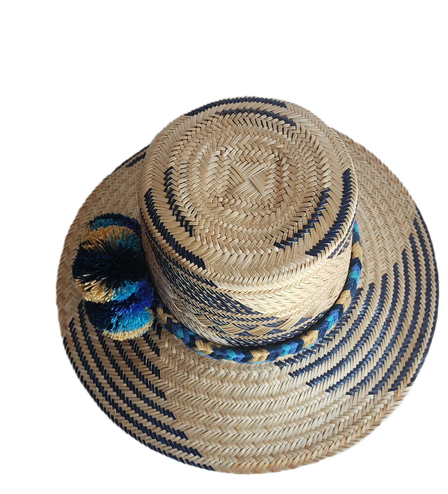 "Handmade, colorful Wayuu hat crafted from Iraca palm, adorned with meaningful pompoms, demonstrating artisan craftsmanship."