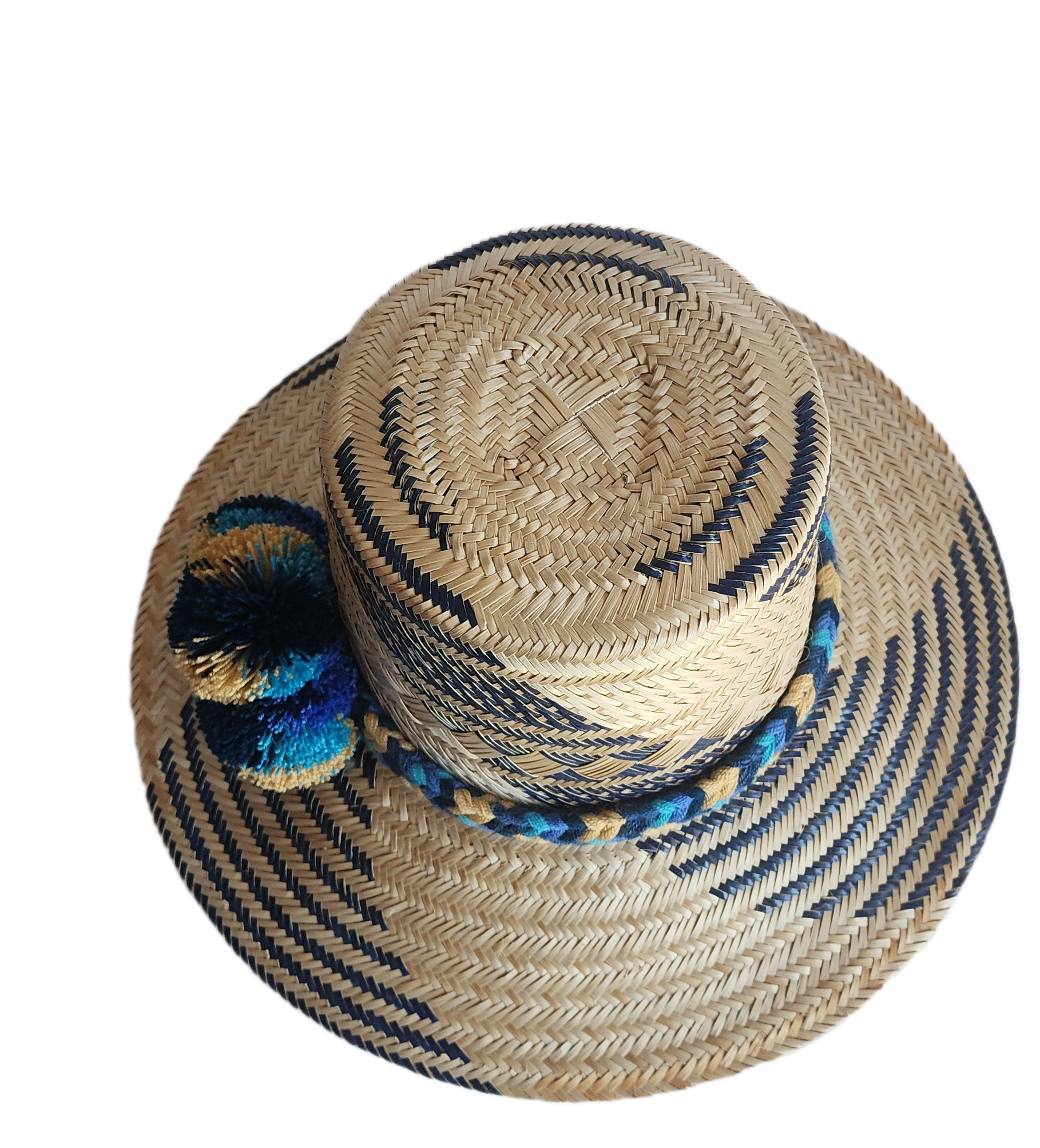 "Handmade, colorful Wayuu hat crafted from Iraca palm, adorned with meaningful pompoms, demonstrating artisan craftsmanship."