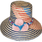 "Handmade colorful Wayuu hat from Iraca palm fiber with vibrant pompoms, showcasing Colombian-Venezuelan artisan craftsmanshi