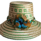 "Handmade colorful Wayuu hat woven from Iraca palm, adorned with culturally significant pompoms, adjustable fit."