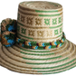 "Handmade colorful Wayuu hat woven from Iraca palm, adorned with culturally significant pompoms, adjustable fit."