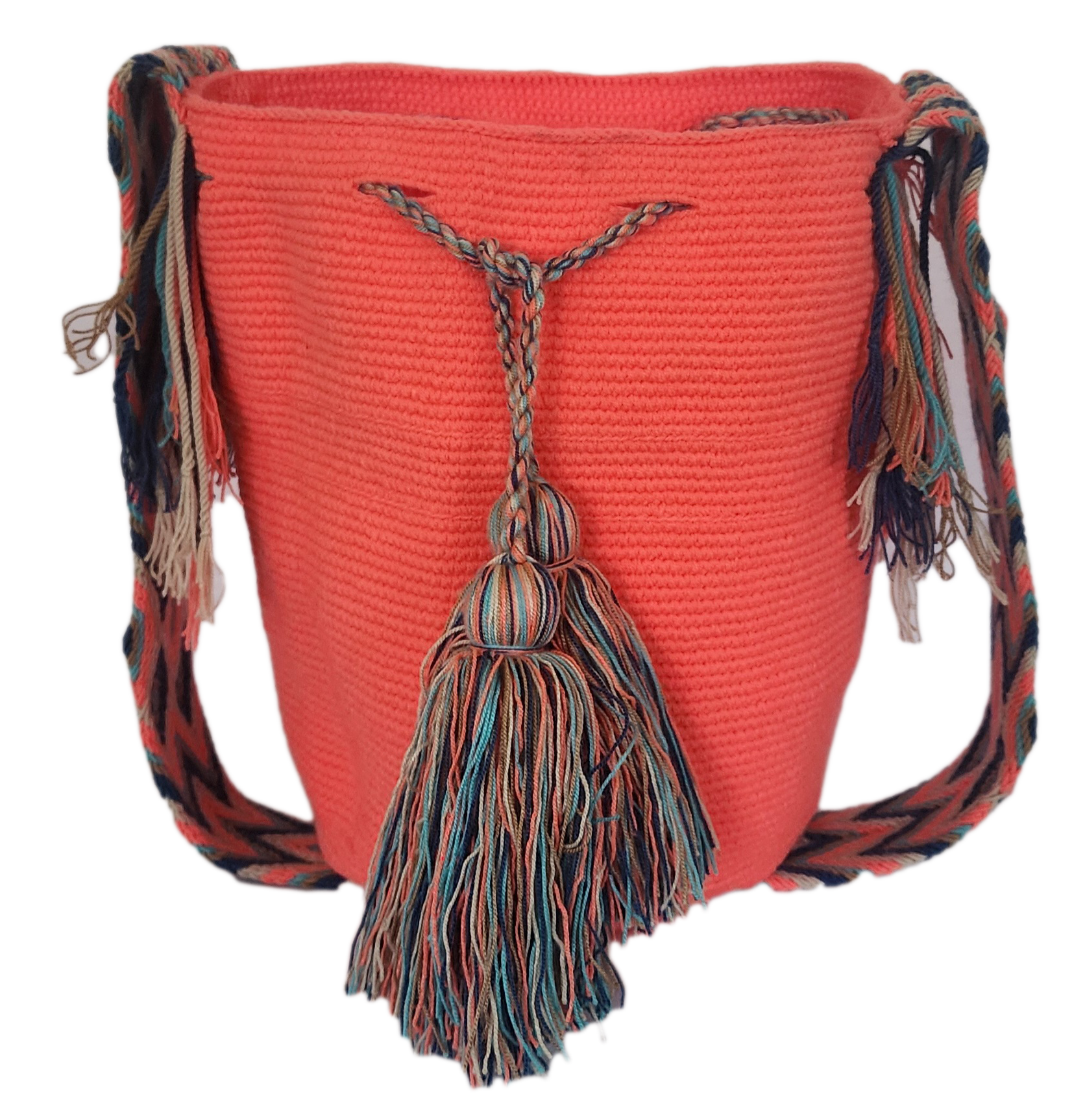 Handmade Wayuu mochila in coral pink with colorful tassel accents and braided shoulder strap — a vibrant, bohemian crochet bag.