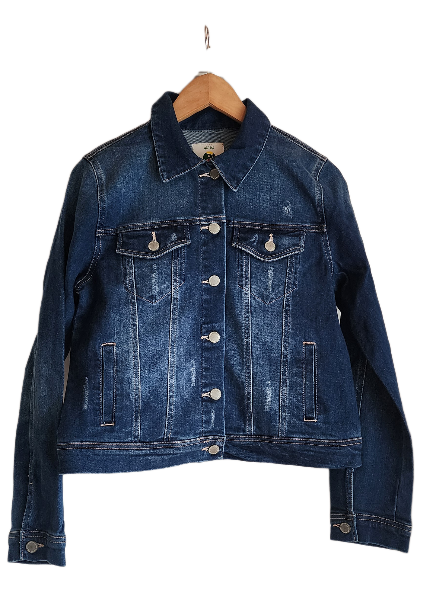 "Handmade denim jacket with colorful Wayuu-inspired punch needle embroidery on the back, showcasing unique bohemian style."