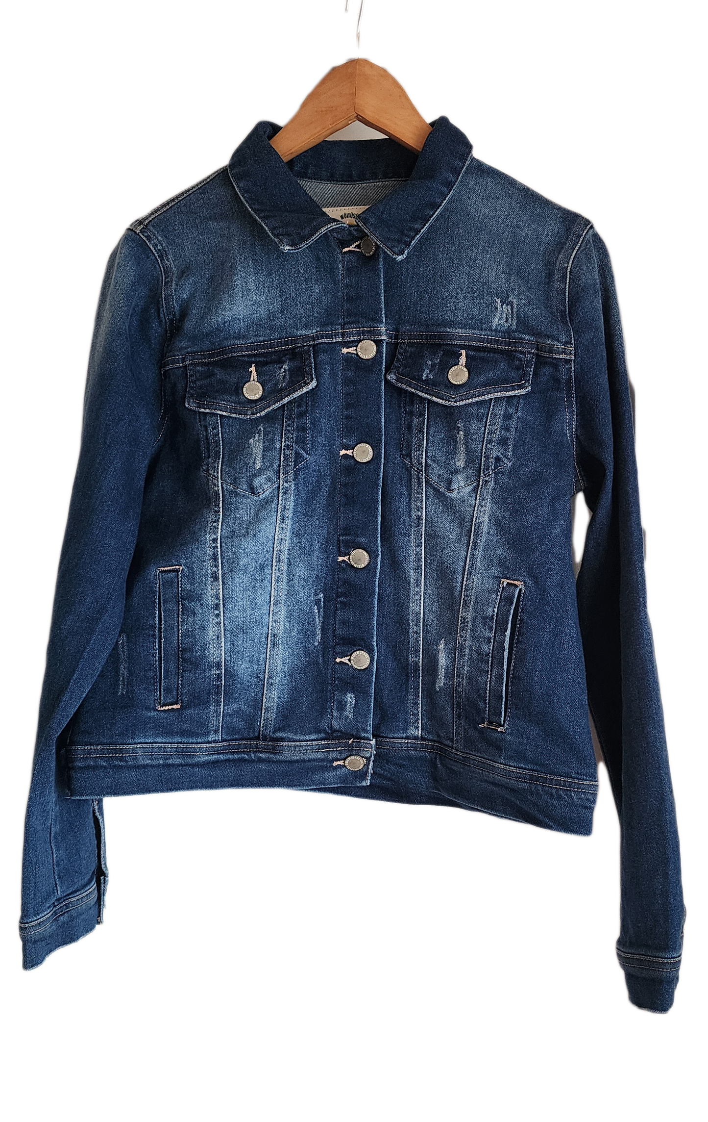 "Handmade denim jacket with colorful Wayuu-inspired punch needle embroidery on the back, showcasing unique artisan craftsmans